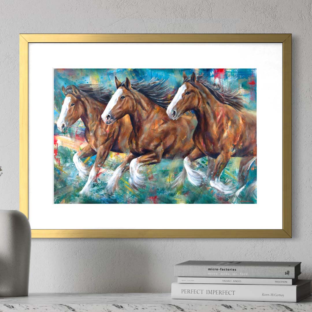 Budweiser Clydesdale horses running by Kyle Lucks as a framed giclée fine art print in a gold frame, front view