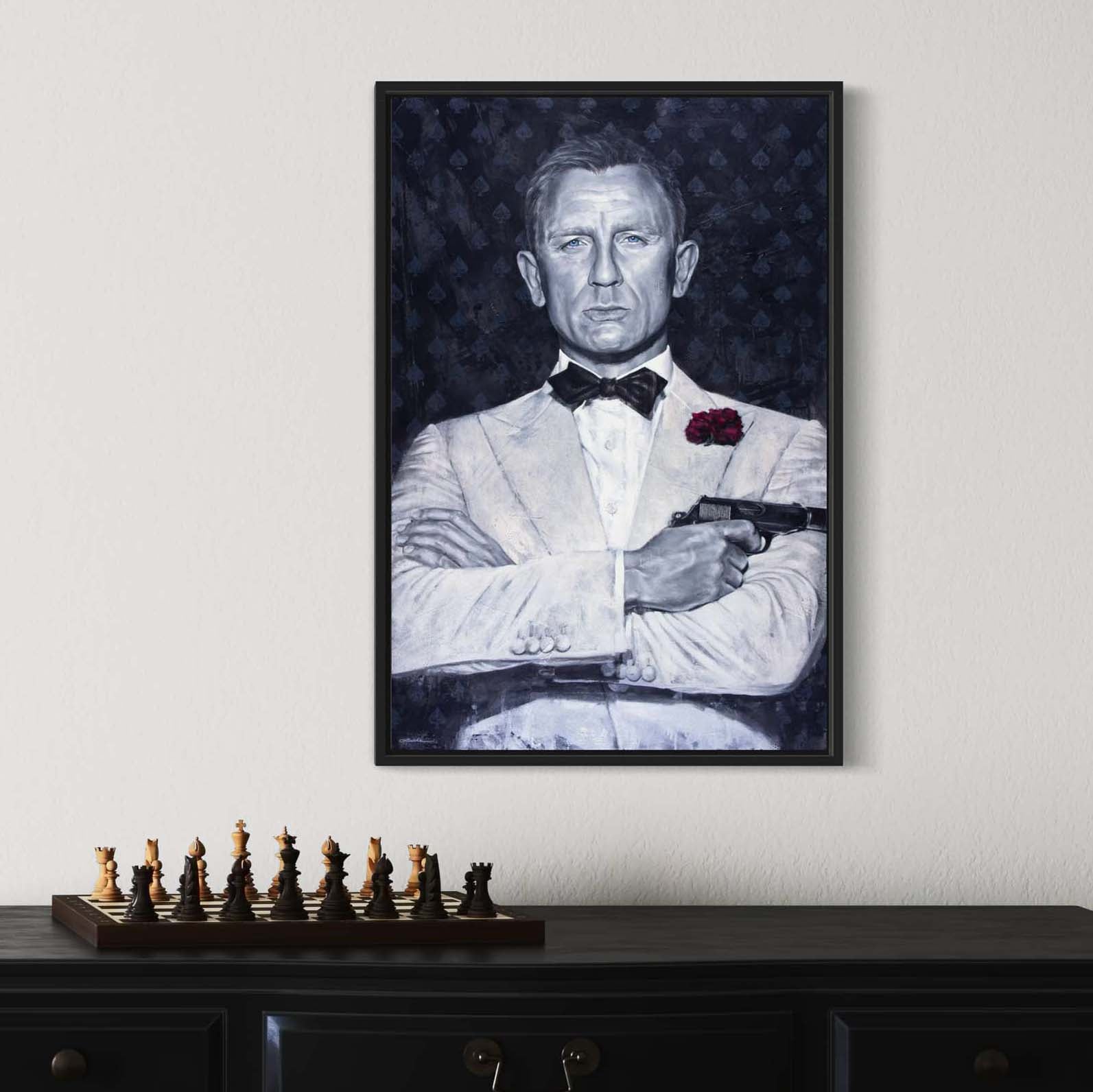 Portrait painting of Daniel Craig as secret agenct James Bond, wearing a white tuxedo, with his arms crossed and holding a gun. Dark gray background with spades symbol and the words Agent 007.