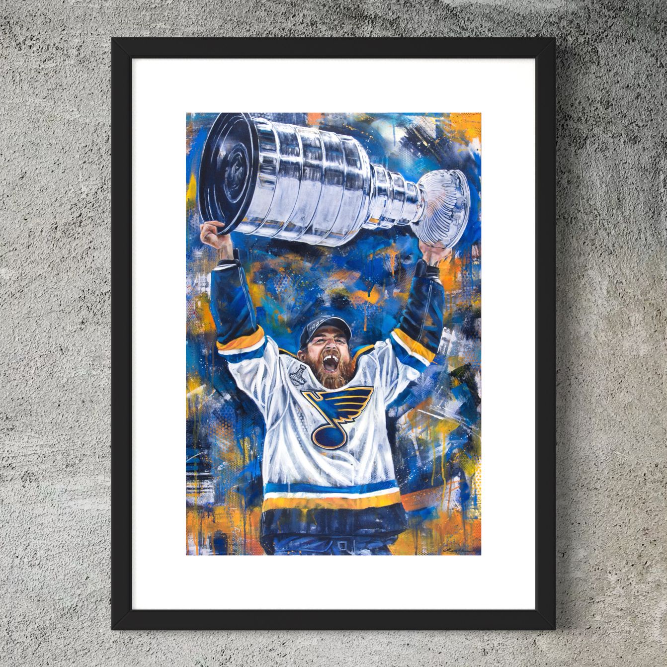 Blues hockey star Ryan O'Reilly hoisting Cup by Kyle Lucks as a framed giclée fine art print in a black frame, front view