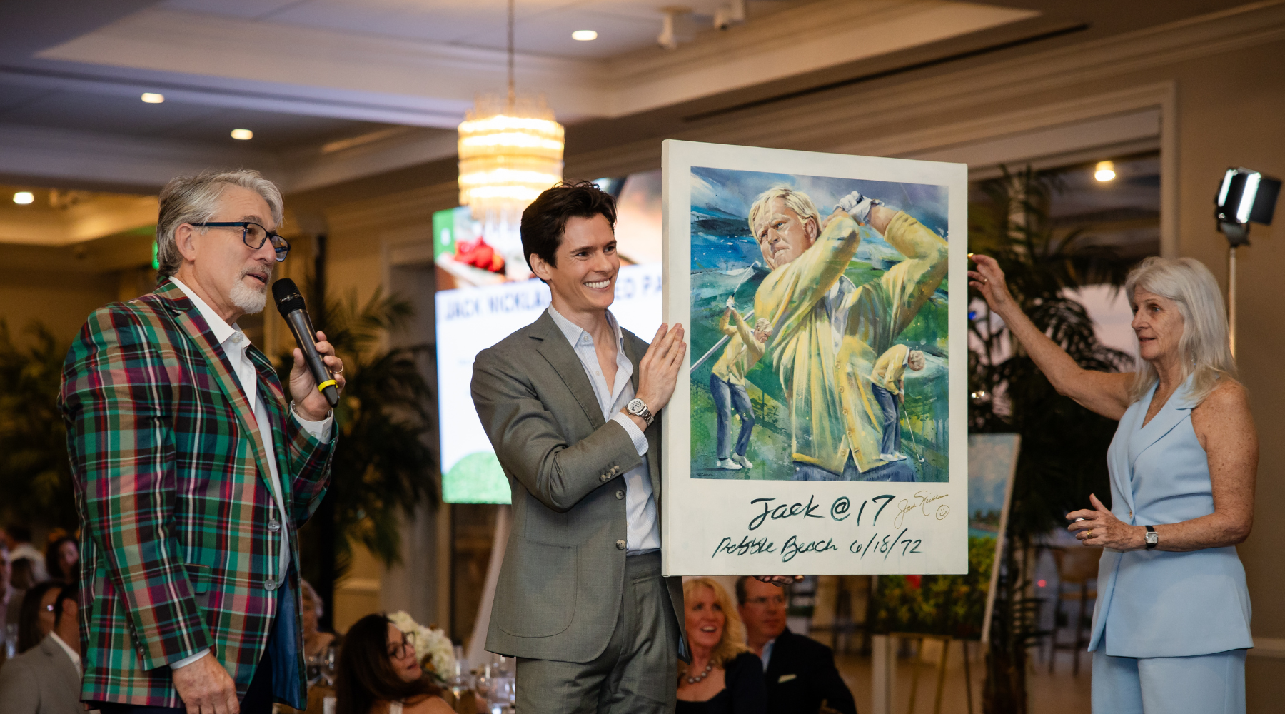 kyle lucks on stage at the chasin a dream foundation event auctioning off an original painting of Jack Nicklaus at Pebble Beach to benefit the children