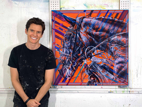 Kyle Lucks beside an original horse portrait painted on a vintage Hermès silk scarf