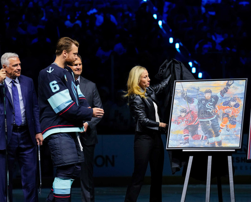 Adam Larsson's 1000th-game portrait by Kyle Lucks unveiled on ice at a Seattle Kraken game