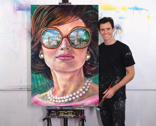 Kyle Lucks beside his 'Jackie at The Breakers' portrait on the easel