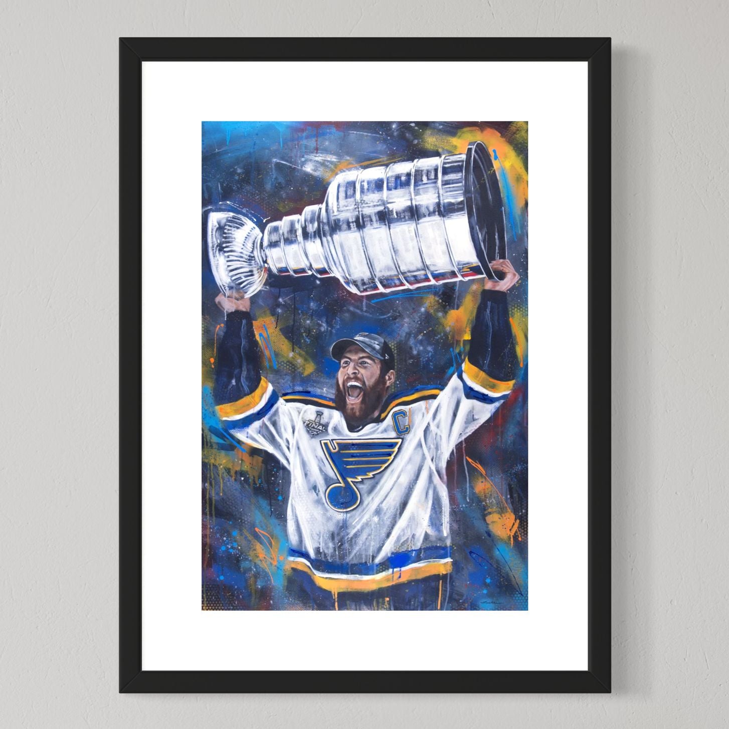 Blues captain Alex Pietrangelo hoisting Stanley Cup by Kyle Lucks as a framed giclée fine art print in a black frame