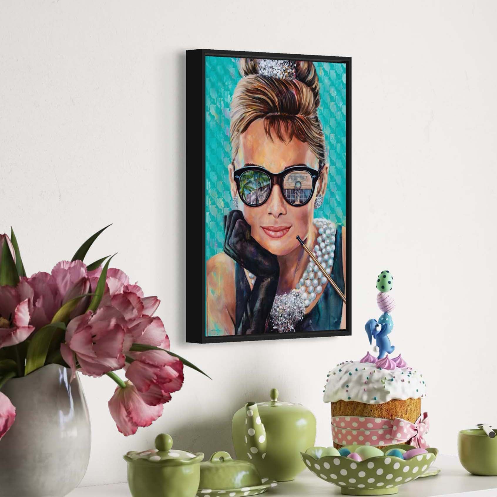 Painted portrait of Audrey Hepburn wearing a pearl necklace and oversized sunglasses with the reflection of the Tiffany & Co. store on Worth Avenue in Palm Beach, Florida. 