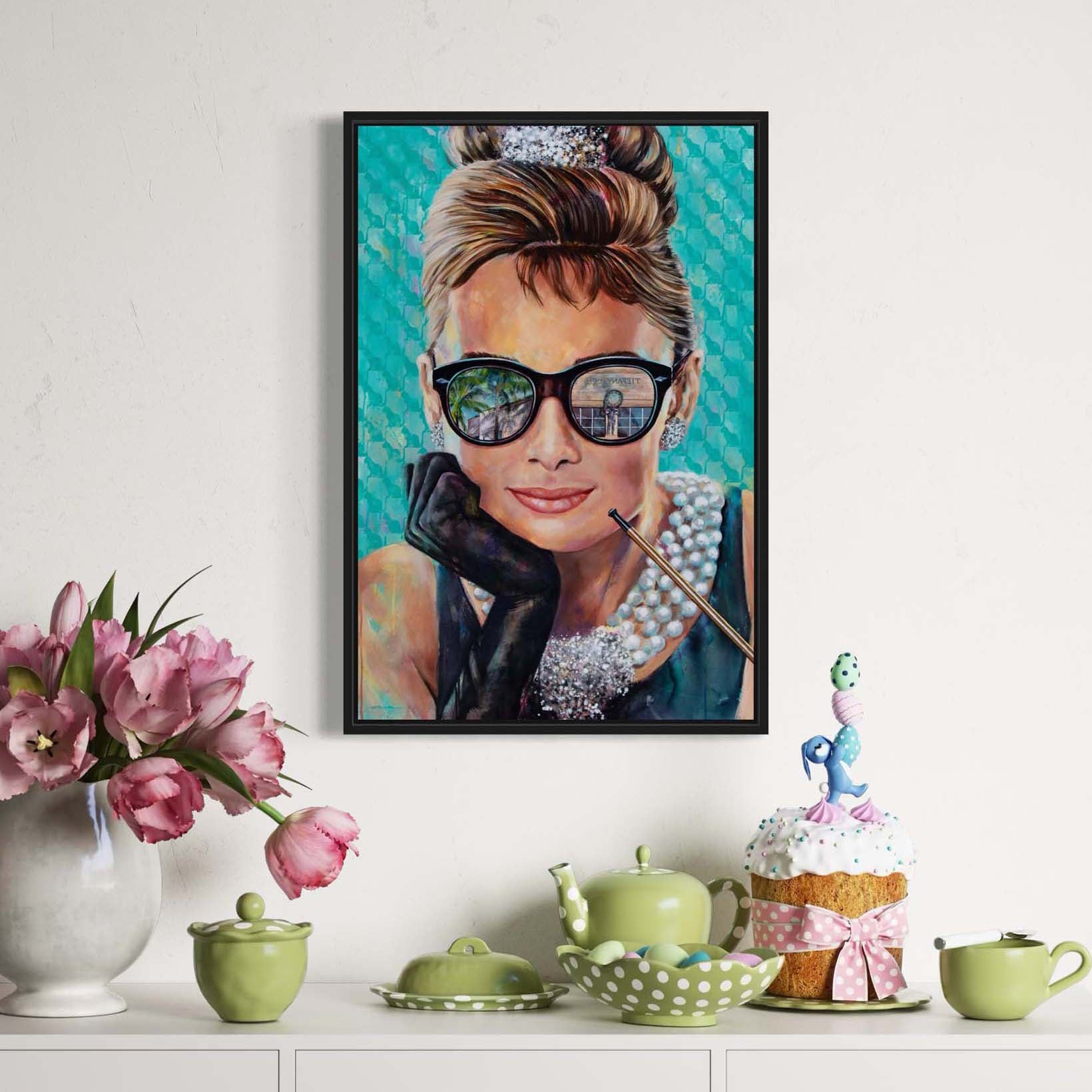 Painted portrait of Audrey Hepburn wearing a pearl necklace and oversized sunglasses with the reflection of the Tiffany & Co. store on Worth Avenue in Palm Beach, Florida. 