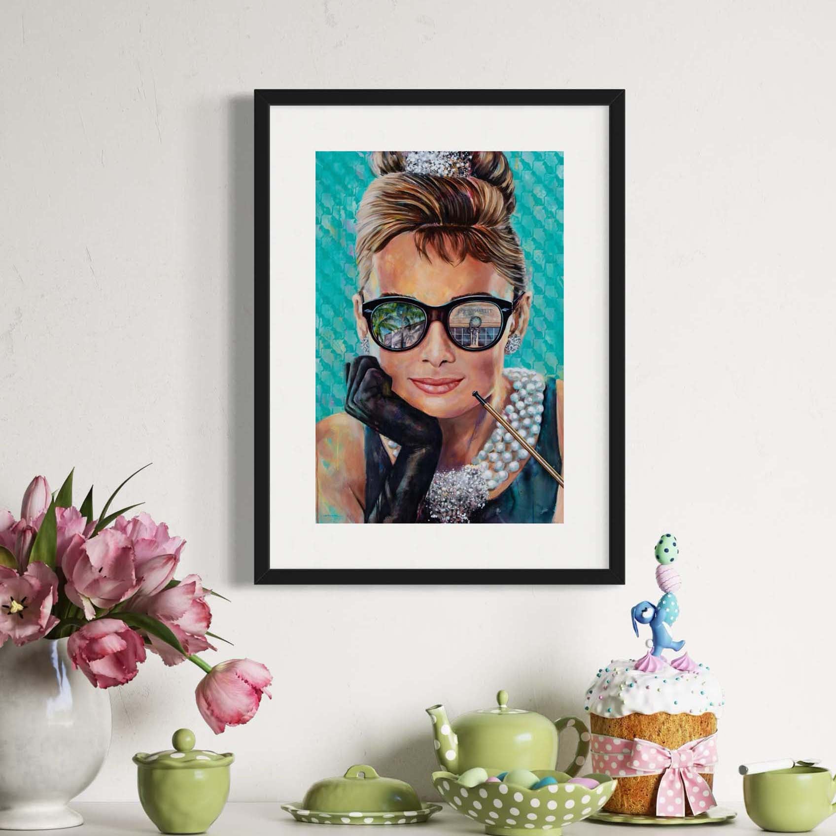 Painted portrait of Audrey Hepburn wearing a pearl necklace and oversized sunglasses with the reflection of the Tiffany & Co. store on Worth Avenue in Palm Beach, Florida. 