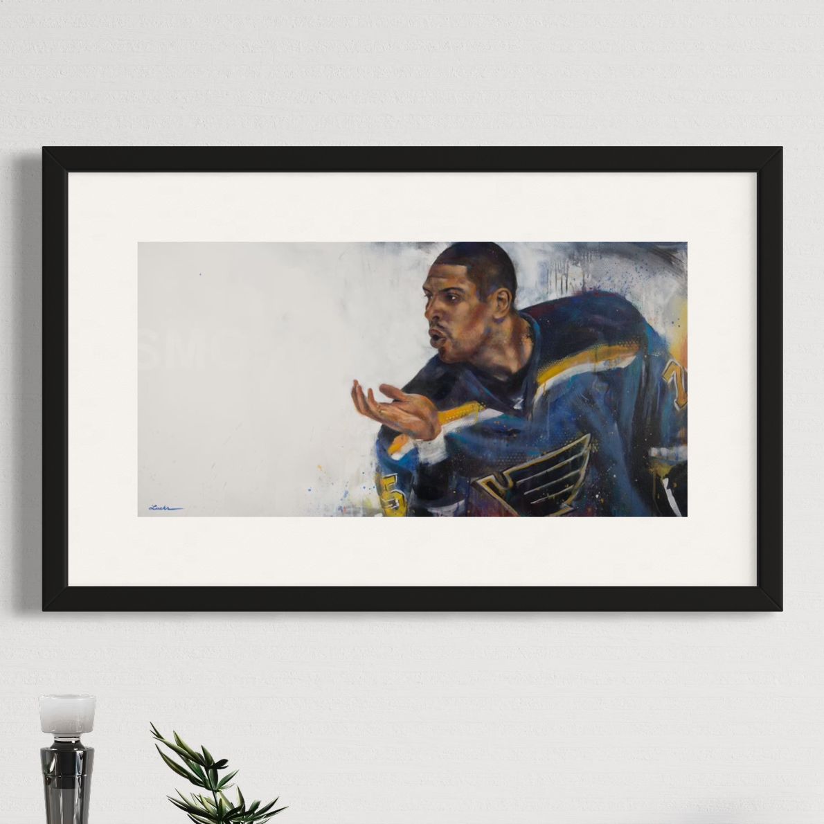 Blues enforcer Ryan Reaves' kiss celebration by Kyle Lucks as a framed giclée fine art print in a black frame, front view