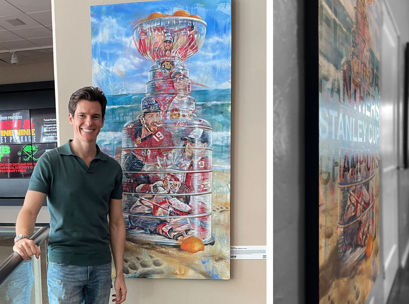 Kyle Lucks standing next to Panthers hockey painting at arena