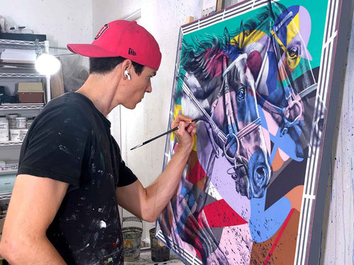 Kyle Lucks painting 'Photo Finish,' a horse racing portrait on silk, in his studio