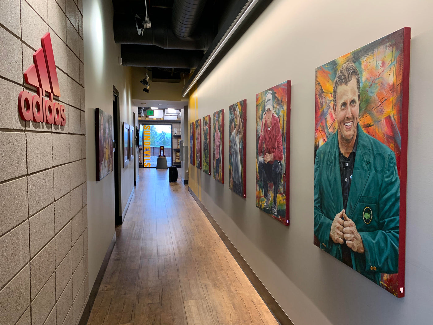 Portraits of Arizona State golfers in a hallway